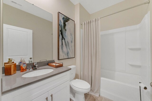 full bathroom featuring vanity, toilet, shower / tub combo, and wood-type flooring