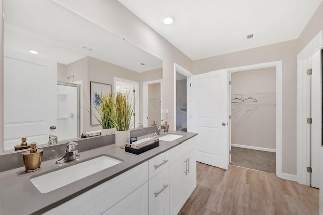 bathroom featuring vanity, hardwood / wood-style floors, and an enclosed shower