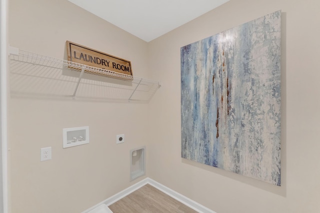 laundry area with hookup for an electric dryer, hardwood / wood-style floors, and washer hookup