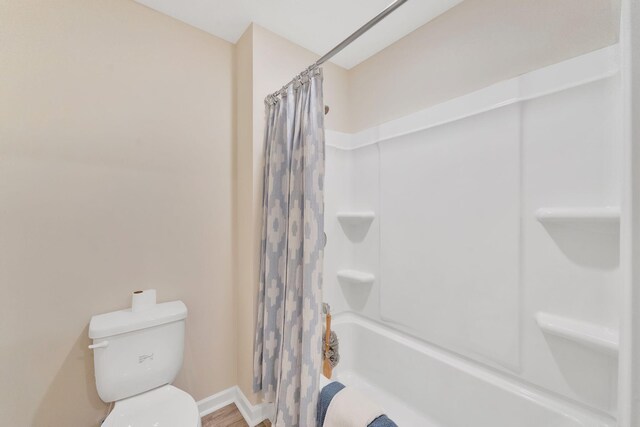 bathroom with toilet and shower / bathtub combination with curtain