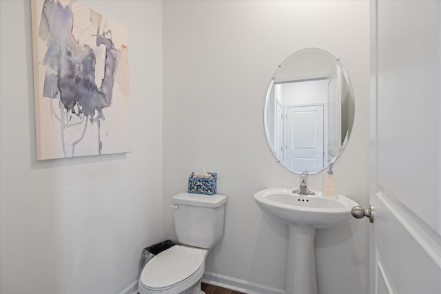 bathroom with toilet and hardwood / wood-style floors