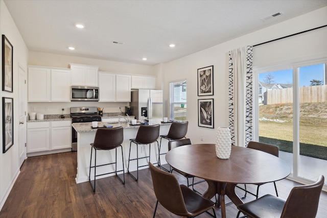 dining space with dark hardwood / wood-style floors