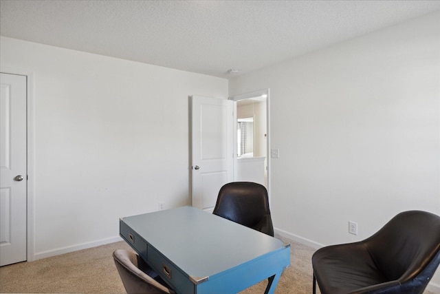 carpeted home office with a textured ceiling