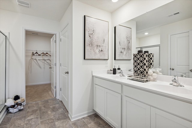 bathroom featuring vanity and a shower