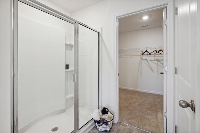 bathroom featuring a shower with door