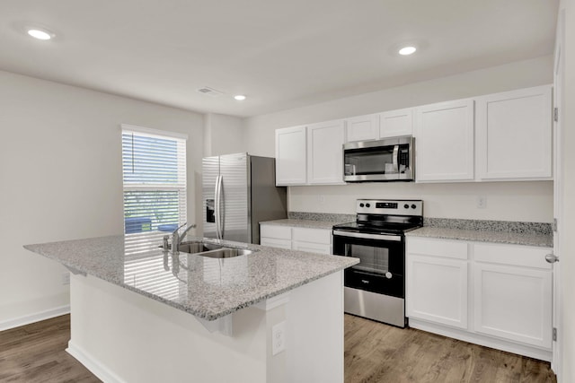 kitchen with white cabinetry, light wood-style floors, appliances with stainless steel finishes, and a sink