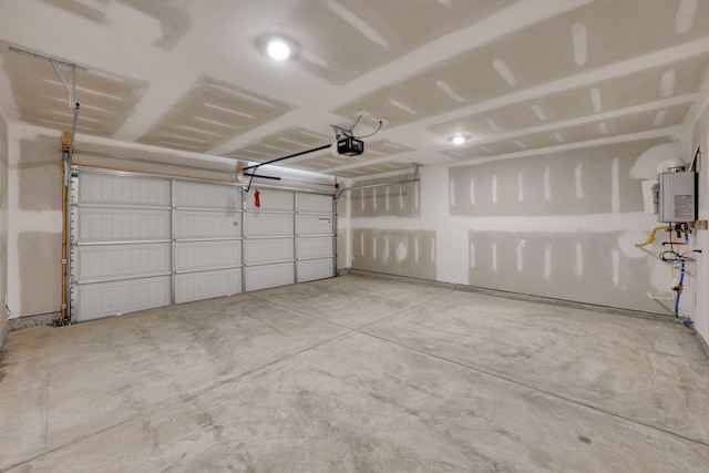garage with a garage door opener and water heater