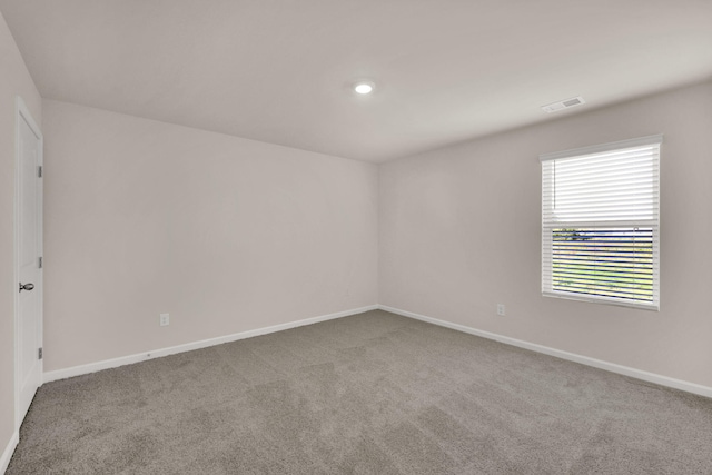 spare room featuring recessed lighting, visible vents, baseboards, and carpet
