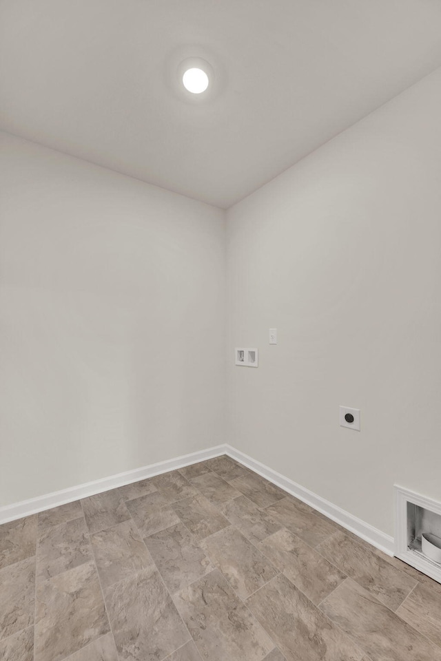 unfurnished room with baseboards