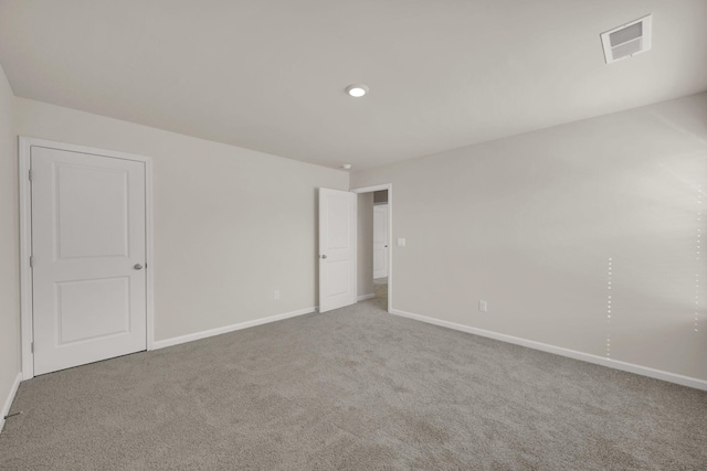 unfurnished bedroom with carpet flooring, baseboards, and visible vents
