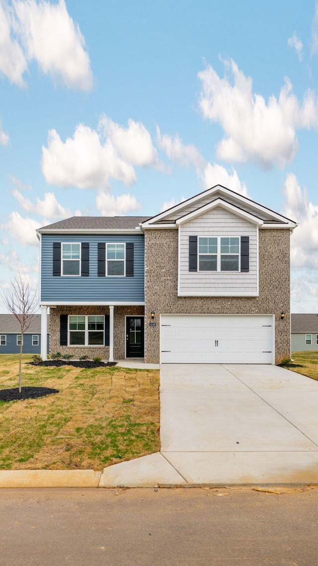 view of front of property with brick siding, driveway, a front lawn, and a garage