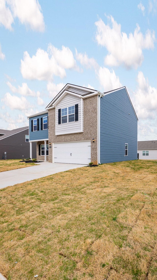 view of front of home with driveway, an attached garage, and a front yard