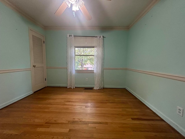 spare room featuring ceiling fan, crown molding, and light hardwood / wood-style floors