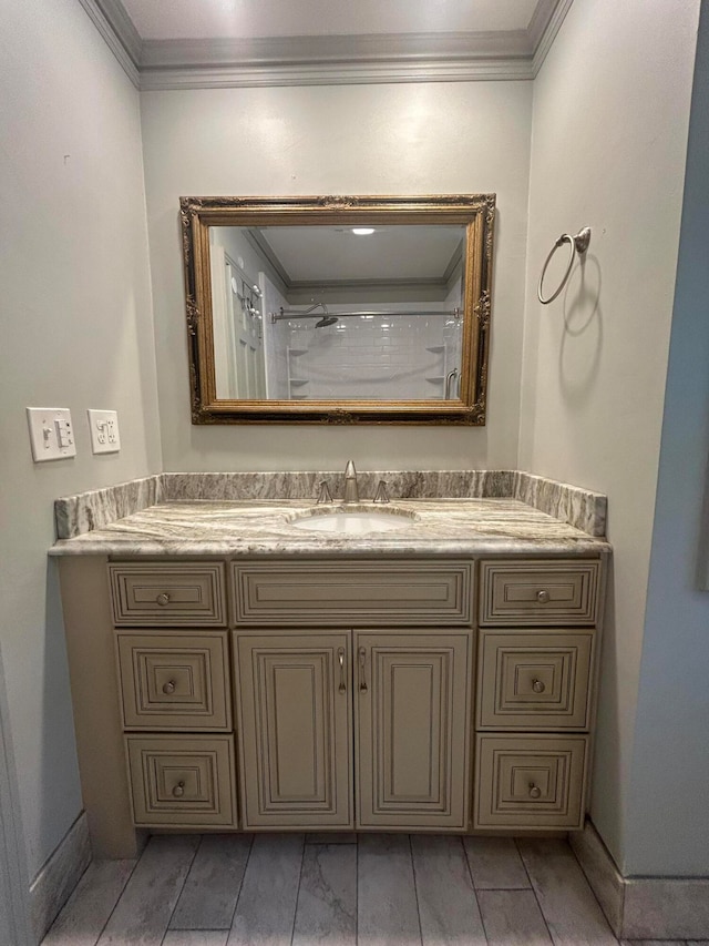 bathroom featuring vanity, a shower, and ornamental molding