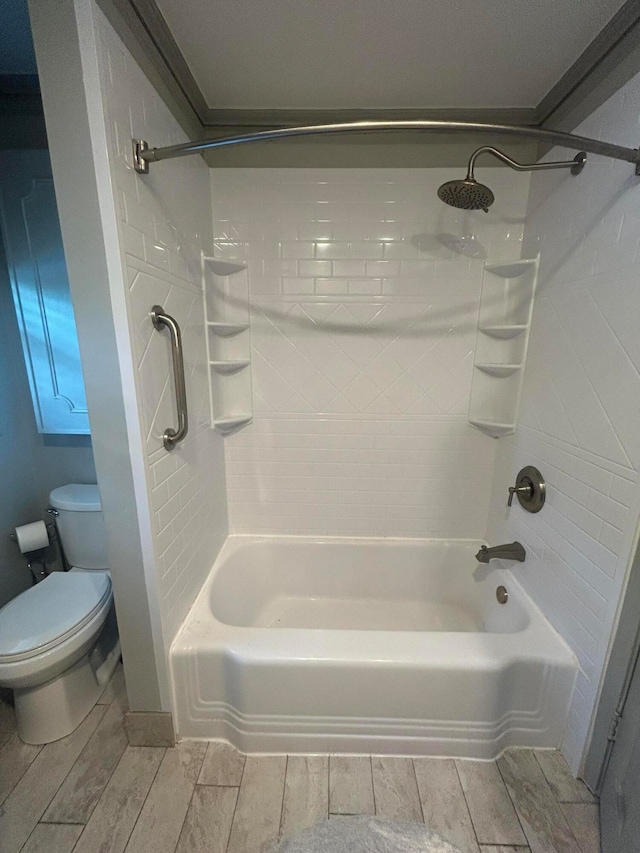 bathroom with bathtub / shower combination and toilet