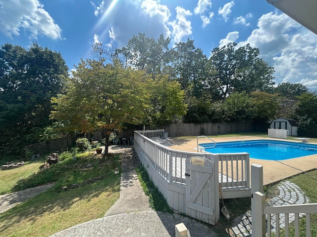 view of pool with a storage shed