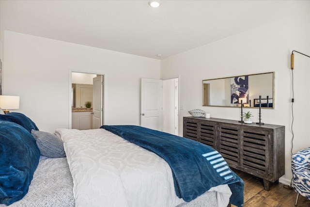 bedroom with hardwood / wood-style floors and ensuite bath