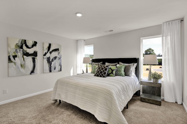 carpeted bedroom with baseboards and visible vents