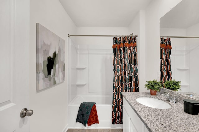 bathroom featuring shower / bath combo and vanity