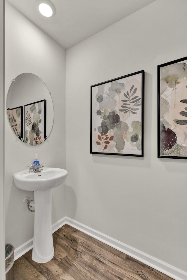 bathroom with wood finished floors and baseboards