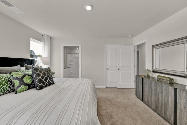 bedroom featuring connected bathroom, baseboards, visible vents, and light carpet