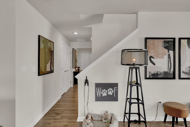 hallway with recessed lighting, baseboards, and wood finished floors