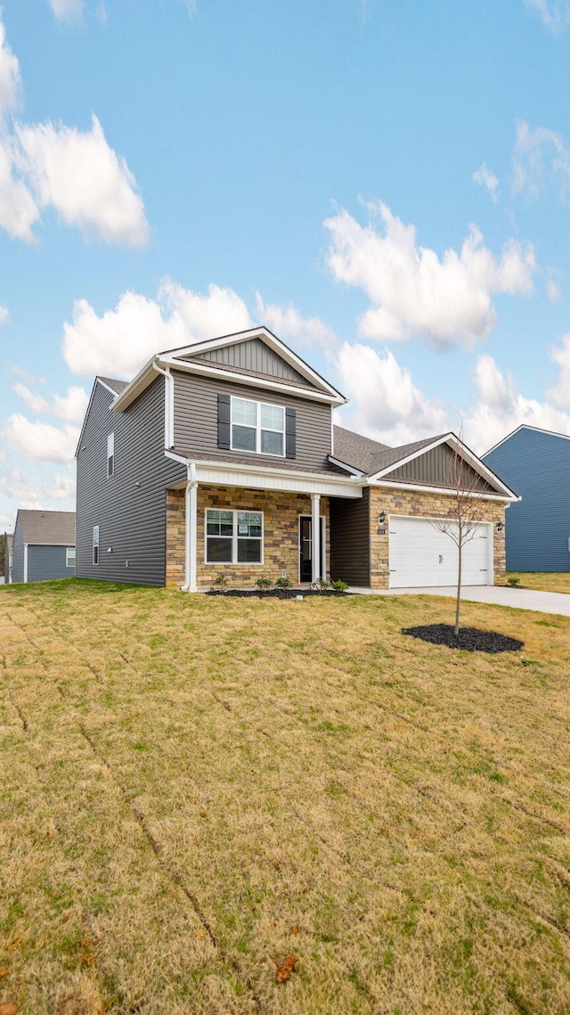 view of front facade with a front lawn, stone siding, board and batten siding, concrete driveway, and an attached garage