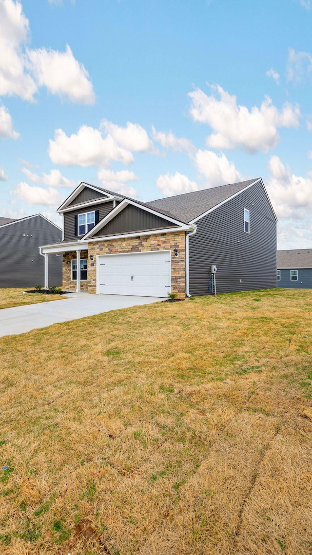 view of front of house with an attached garage, driveway, and a front lawn