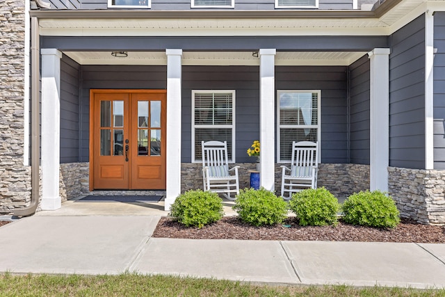 doorway to property featuring covered porch and french doors