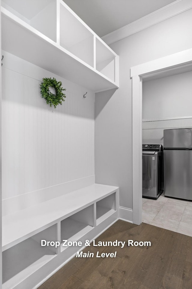 mudroom featuring crown molding, separate washer and dryer, and hardwood / wood-style floors