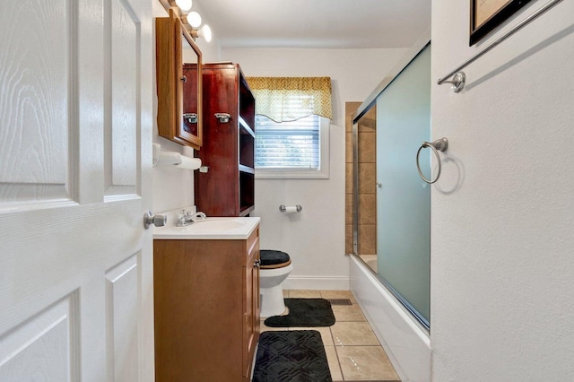 bathroom featuring toilet, tile patterned floors, shower / bath combination with glass door, and vanity