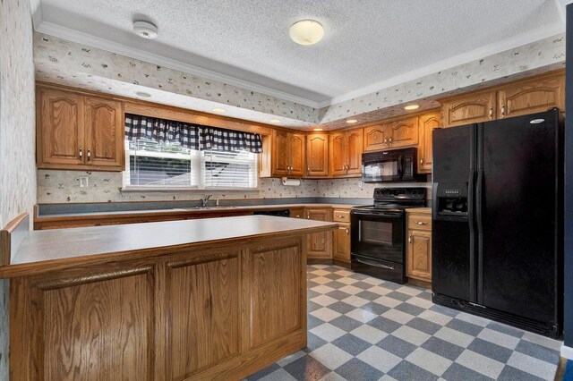kitchen featuring a textured ceiling, brown cabinets, black appliances, light floors, and ornamental molding