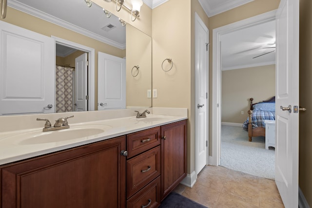 bathroom featuring tile patterned flooring, crown molding, and vanity