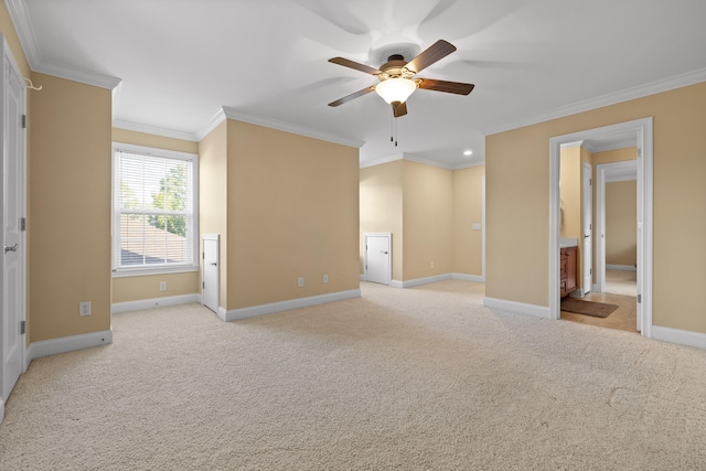 empty room with ornamental molding, light colored carpet, and ceiling fan