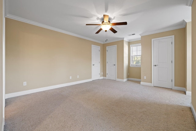 carpeted spare room featuring ceiling fan and ornamental molding