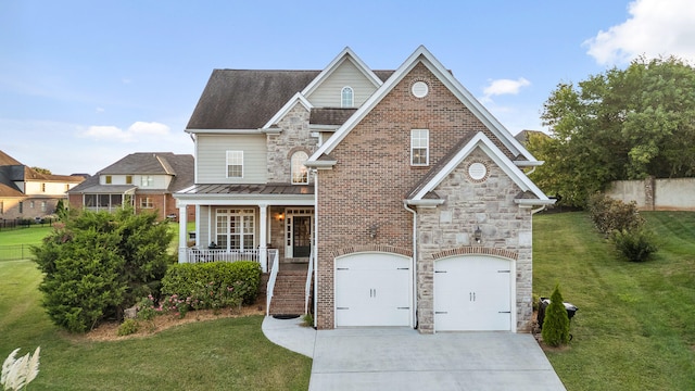 view of front of property featuring a front yard, a garage, and a porch