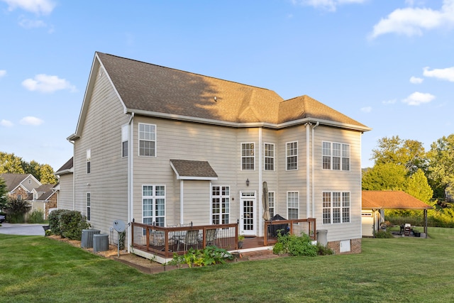 back of house featuring a lawn, a wooden deck, and central AC