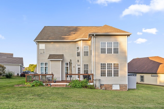 back of property with a yard and a wooden deck