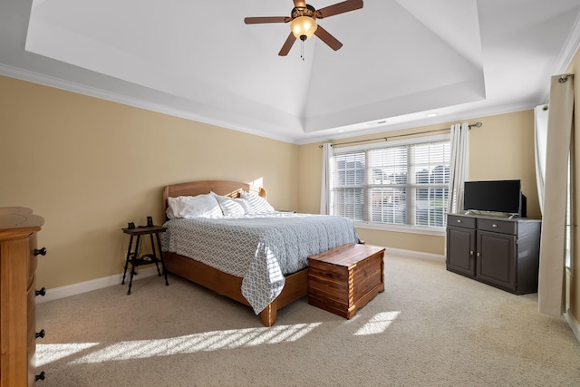 bedroom with a tray ceiling, light colored carpet, crown molding, and ceiling fan