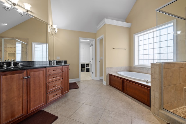 bathroom with vanity, lofted ceiling, plenty of natural light, and separate shower and tub