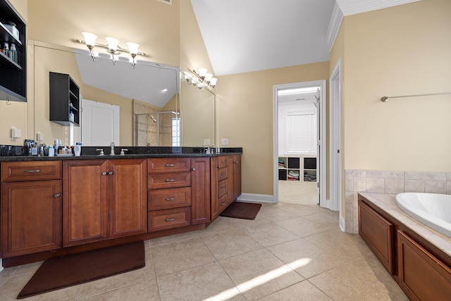 bathroom with tile patterned floors, vaulted ceiling, independent shower and bath, vanity, and ornamental molding