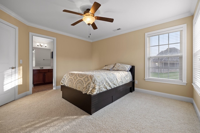 carpeted bedroom featuring crown molding, ceiling fan, and ensuite bathroom