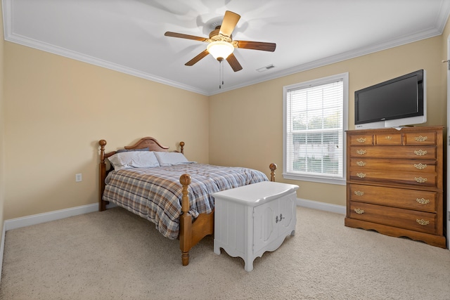 carpeted bedroom with ceiling fan and ornamental molding