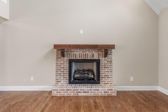 details with hardwood / wood-style flooring and a brick fireplace