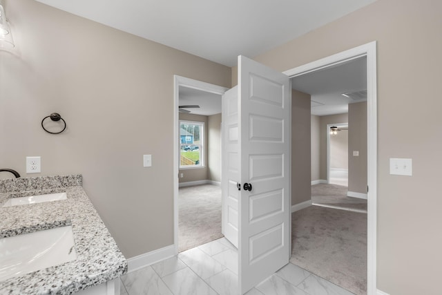 bathroom featuring ceiling fan and vanity