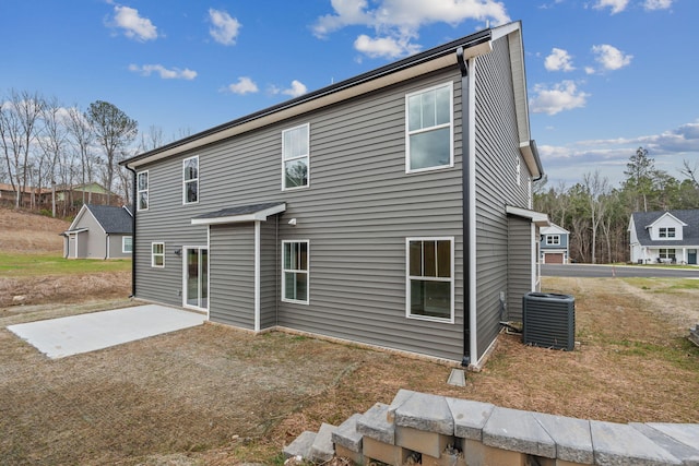 rear view of property featuring a patio and cooling unit