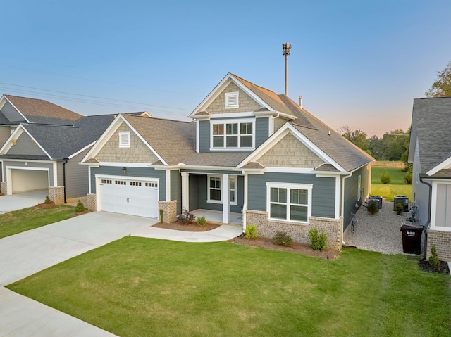 craftsman-style home with covered porch, central AC unit, and a lawn