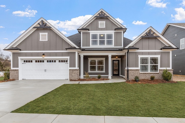 craftsman-style house featuring a garage and a front lawn