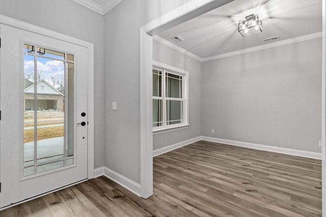 foyer entrance featuring hardwood / wood-style floors and crown molding