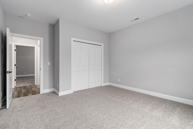 unfurnished bedroom featuring a closet and carpet